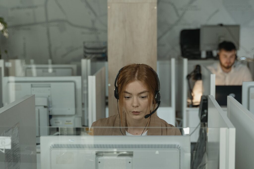 Call center agent sitting at a desk wearing a headset